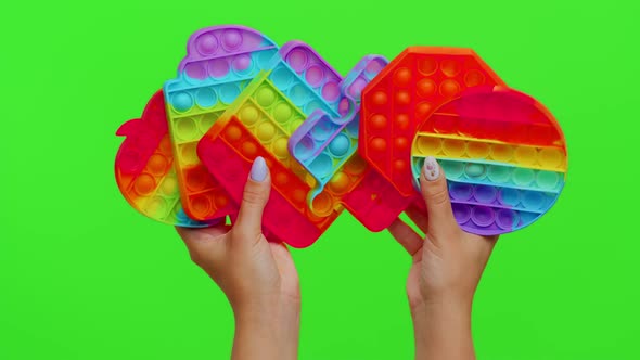 Female Hands with Push Pop It Bubble Fidget Stress Anxiety Relief Squeeze Sensory Toys on Chroma Key alt