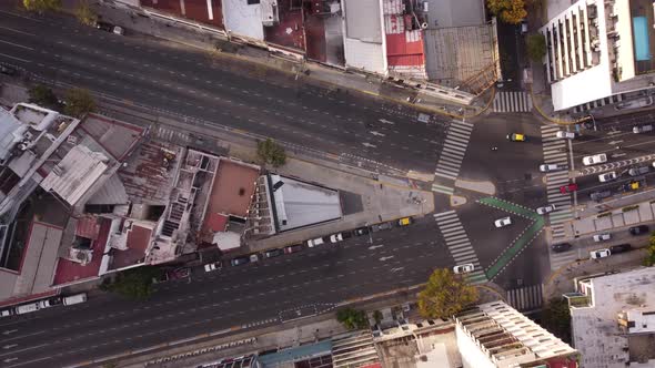 Aerial top down of vehicles diverting towards different lanes from intersection at Cordoba Avenue fo alt