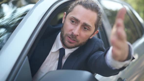 Nervous Young Man Yelling Arguing Leaning Out Car Window Standing in Traffic Jam alt