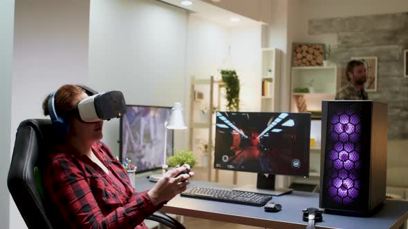 Gamer Girl Losing Video Game Tournament While Playing with VR Headset alt