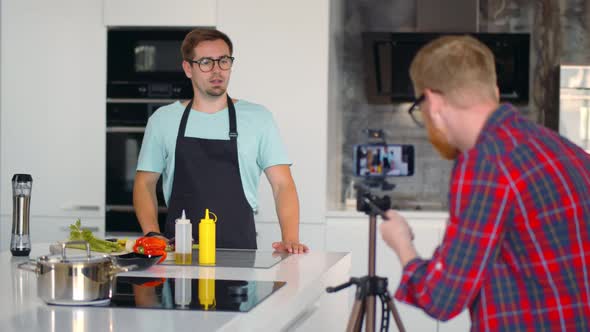 Make-up Artist Fix Makeup of Handsome Man Filming Cooking Show or Blog alt