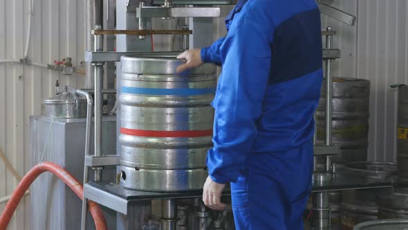 Worker Wash Keg From a Beer on a Beer Line. Beer Keg Production Line. Brewery.