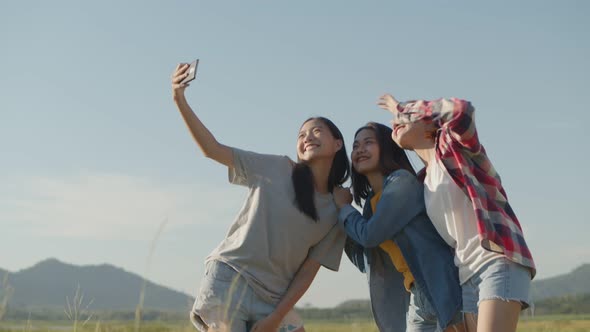 Asian women taking selfies having fun together a summer traveling.