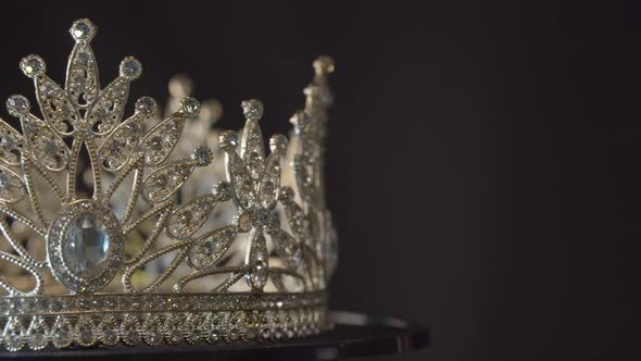 Beauty pageant, bride's or queen's crown on a turning display as in a museum, illuminated with black alt