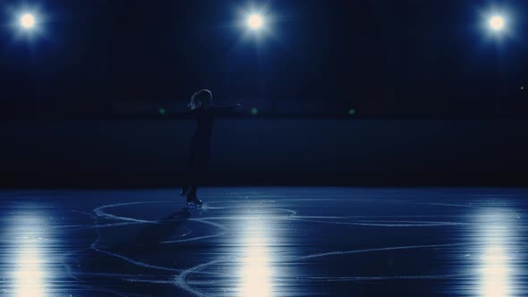 Female Artistic Figure Skater is Performing Single Skating Choreography on Ice Rink Against Soft alt