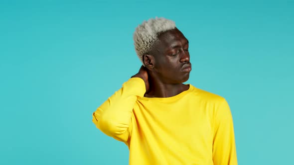 Young African American Man Having Pain in the Neck, Studio Portrait. Guy Putting Hands on Throat alt