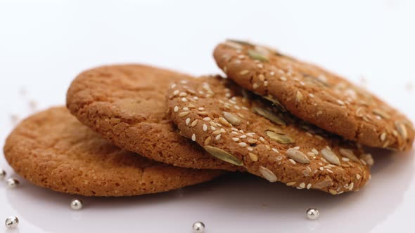 Oatmeal Cookie Rotation on the Table With Sesame Seeds on White Background