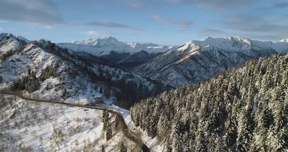 Forward Aerial Top View on White Snow Mountain Pass Valley in Winter