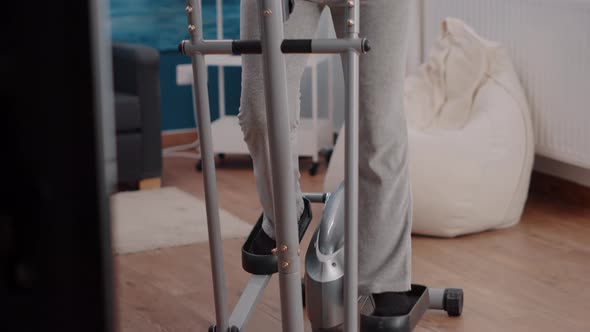 Elder Adult Doing Cycling Exercise on Stationary Bicycle alt