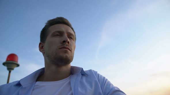 Thoughtful Caucasian Man Standing Against Sky Background, Thinking About Life