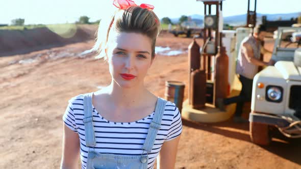 Woman standing near a car at petrol pump 4k alt