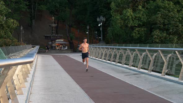 Muscular Young Sportsman Jogging Outdoor for Training Stamina