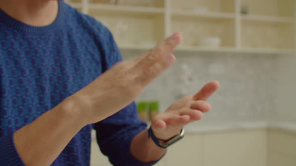 Closeup of Male Hands Using Sign Language for Communication Indoors alt