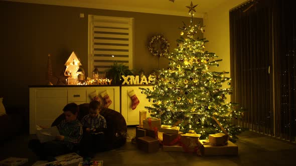 Children Playing With Christmas Presents at Home