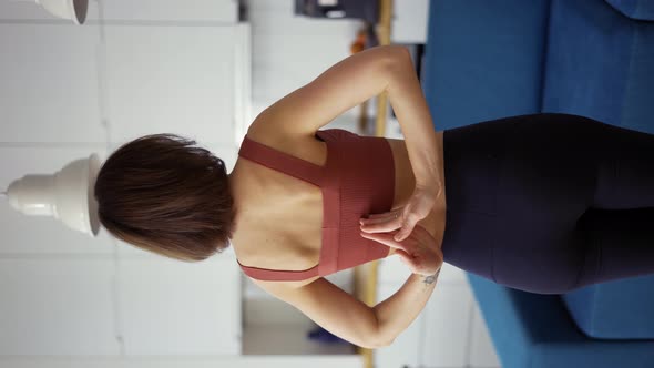Rear View of a Woman Connecting Hands Behind Her Back Yoga Concept alt