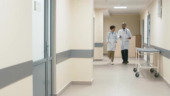 Doctor and nurse in hospital hallway