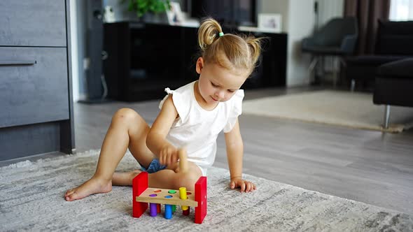 Cute Caucasian Little Girl Playing on the Floor at Home with Eco Wooden Toys alt