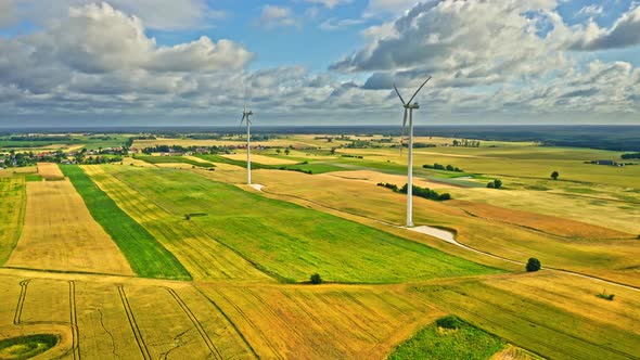 Wind turbines on green field. Alternative energy. Aerial view alt