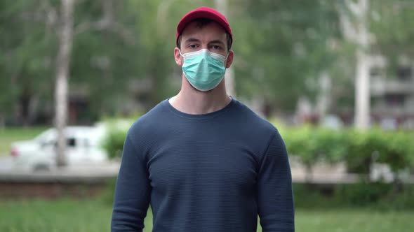 Pandemic Portrait of a Young Man Wearing Protective Mask Outdoors