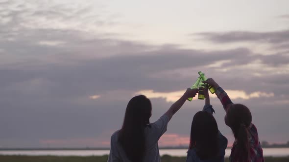 Group of young teen Asian women happy friends camping in nature having fun together drinking beer.