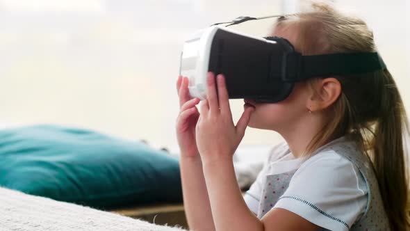 Little Girl Playing Video Game in VR Headset