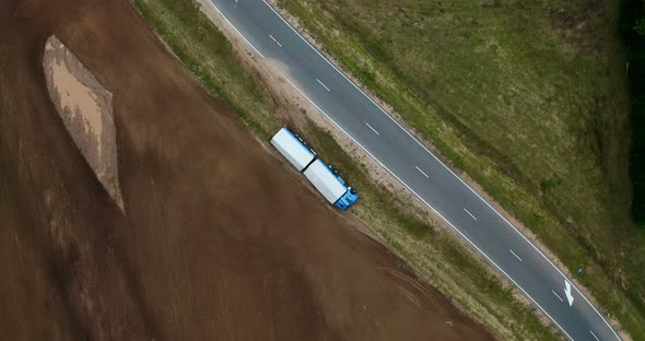 Truck crash drone shooting. Truck lies inverted in a ditch. Truck driver has an accident