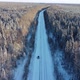 Aerial View From a Drone of a Road in the Middle of Snowcovered Trees and Snowcovered Forest on a - VideoHive Item for Sale