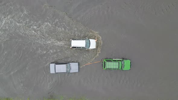 Aerial View of City Traffic with Cars Driving on Flooded Street After Heavy Rain alt