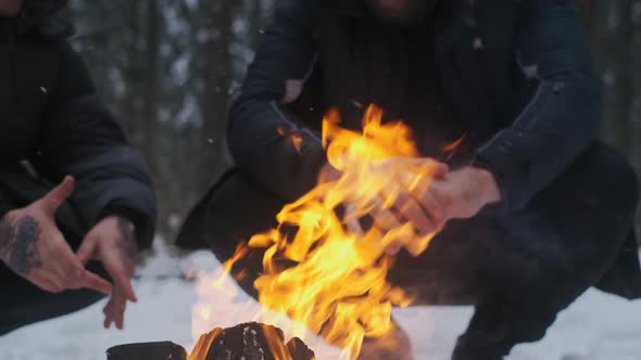 Men Enjoys the Fire at Camping in the Winter Woods Making a Fire Camping in Snowy Forest Men's alt