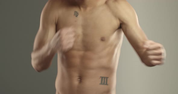 Closeup of Sportsman Bare Torso with Abs Boxer Chest and Hands Athlete Do Shadowboxing Exercises alt