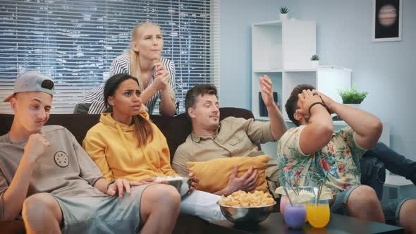 Medium Close Up of Mixed Race People Feeling Sad and Stressed of Match Fail Watched on TV alt