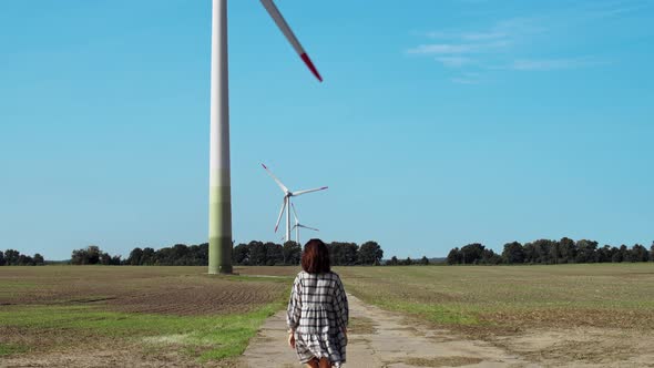 Woman Walks Near The Windmills alt