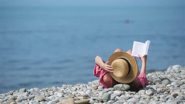Young Woman Reading Book During Tropical White Beach