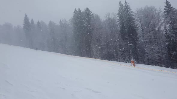 Person skiing on the snowy slope of Bukovel ski resort in the Ukrainian Carpathian mountains