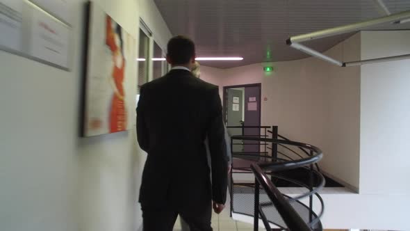 People Walking Through An Office Building. alt