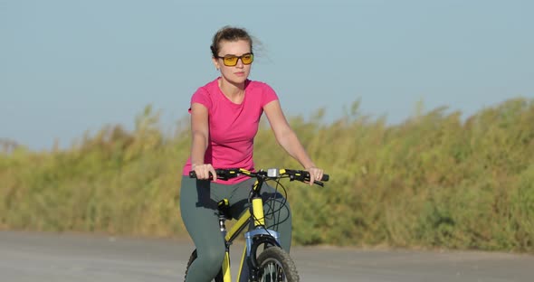 Cyclist Rides a Yellow Bike, Pedals