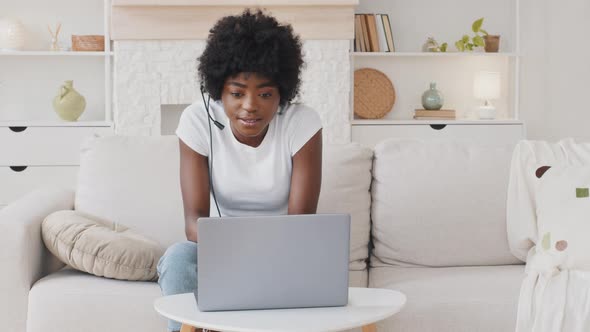 Happy African American Young Woman Wear Headset Communicating By Conference Call Speak Looking at alt