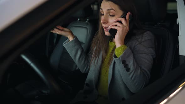 Woman is Angry and Upset on the Steering Wheel Because Her Car Broke Down alt