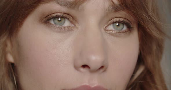 Beautiful Young Woman Opening Her Green Eyes