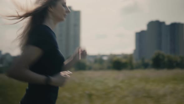 Running Legs And Foot.Woman Running Workout.Fit Woman Cardio Training.Runner Workout On Grass Field alt