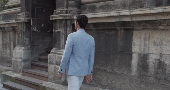 The Guy Walks Near The Old Building alt