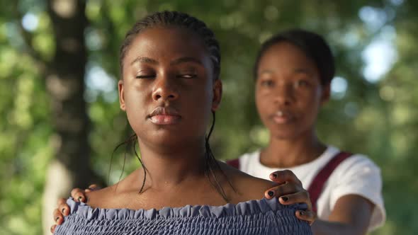 Beautiful African American Sad Woman in Summer Park Looking Away As Friend Touching Shoulders alt