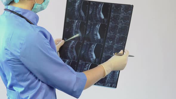 Professional Surgeon Looking on Neck X-Ray, Making Diagnosis, Treating Patient alt