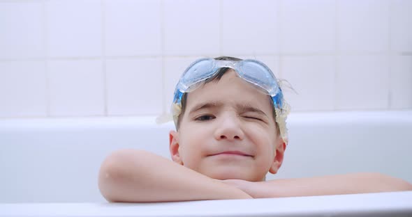 Boy Winking in Bathtub