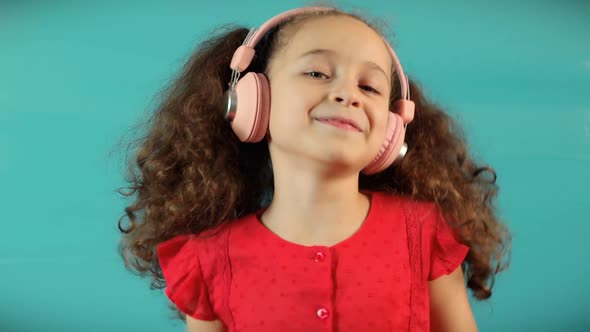 Child On Relaxing on With Eyes Closed Wearing Headphones alt