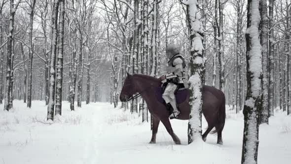 Portrait of Medieval Horseman Wearing Steel Armor Riding Through Winter Forest Among Snowy Trees in alt