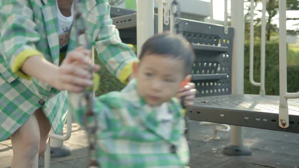 happiness cheerful asian male child play fun relax leisure weekend at park playground alt