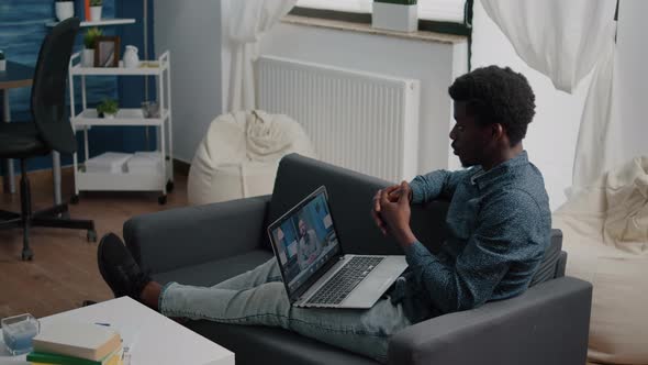 Remote African American Worker on Internet Web Online Communication Talking with His Boss alt