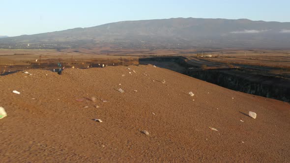 Close Up Remaining Plastic Litter Flying Wind on Landfill Hill at Sunset  USA alt