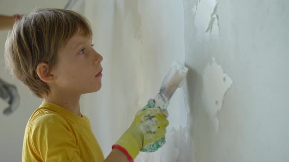 A Young Man and His Son are Doing a Walls Renovation in Their Home alt